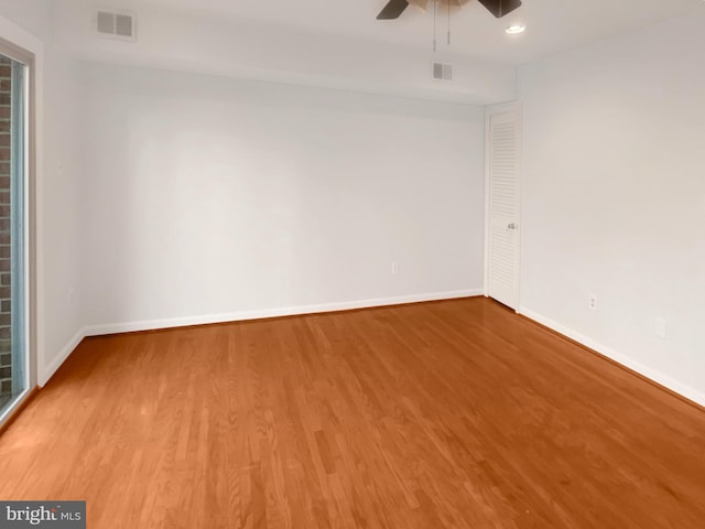 unfurnished room with visible vents, baseboards, ceiling fan, and wood finished floors