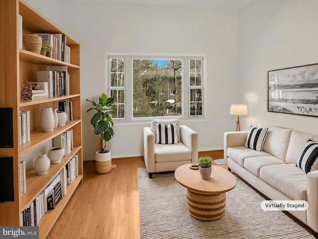 interior space with baseboards and light wood finished floors