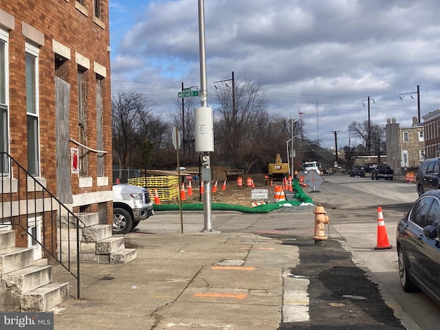 view of road featuring traffic signs and sidewalks