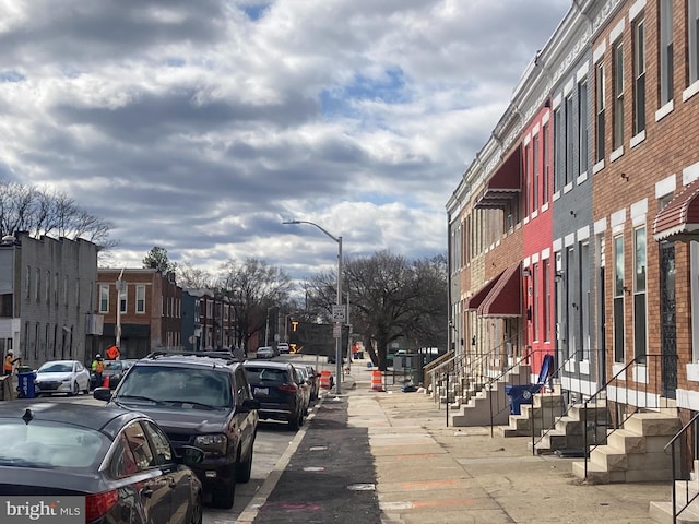 view of street with street lights, traffic signs, and sidewalks