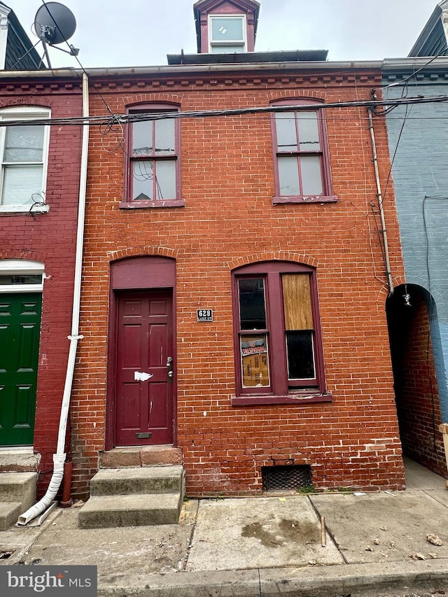 view of front of property with brick siding and entry steps