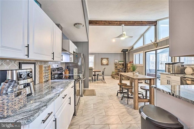 kitchen featuring marble finish floor, electric stove, tasteful backsplash, white cabinets, and light stone countertops