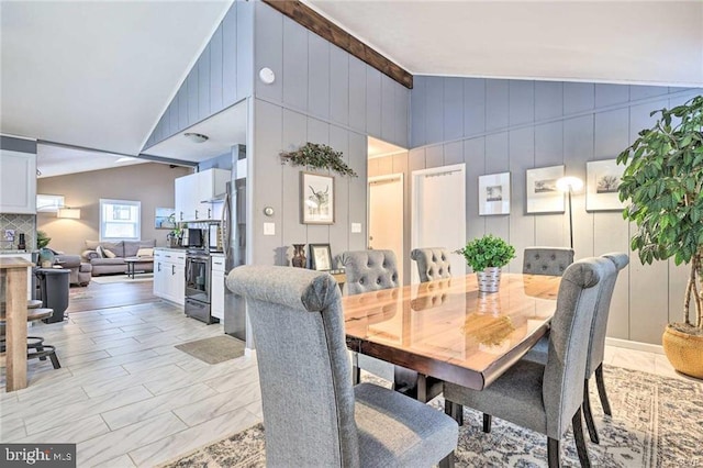 dining area featuring lofted ceiling