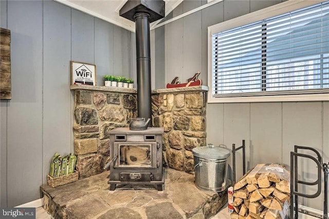 details with a decorative wall and a wood stove