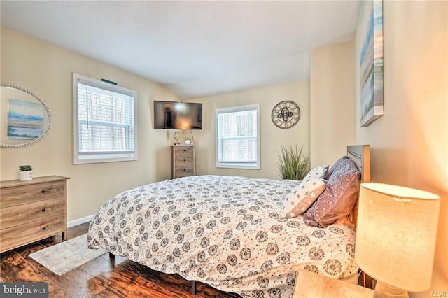 bedroom featuring baseboards and wood finished floors