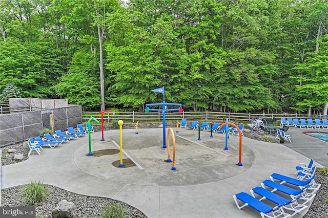 view of property's community with fence and playground community