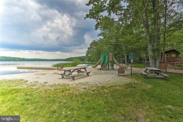 community play area with a yard and a water view