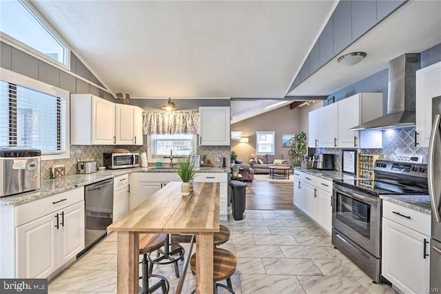 kitchen featuring electric range, marble finish floor, wall chimney range hood, dishwasher, and vaulted ceiling