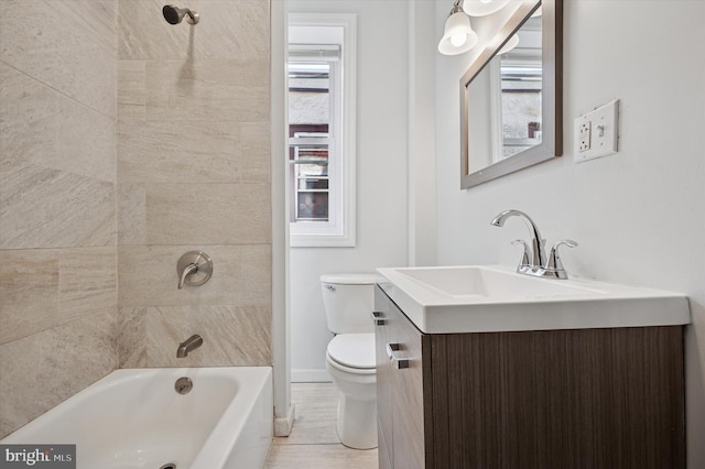 full bath featuring tub / shower combination, baseboards, toilet, and vanity