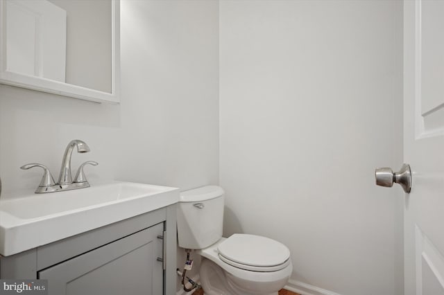 bathroom featuring toilet and vanity