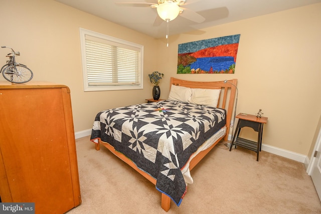 carpeted bedroom featuring baseboards and ceiling fan