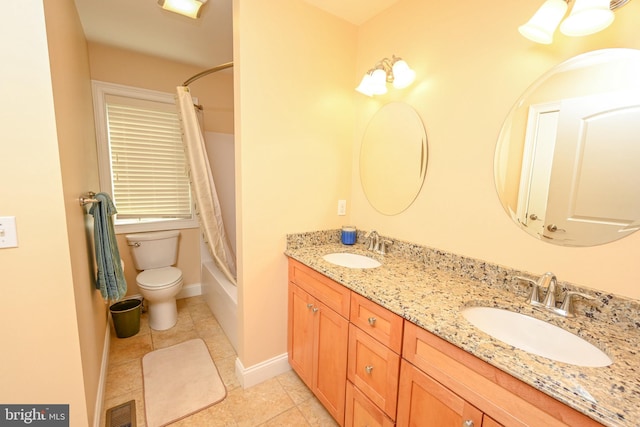 full bathroom featuring a sink, visible vents, toilet, and double vanity