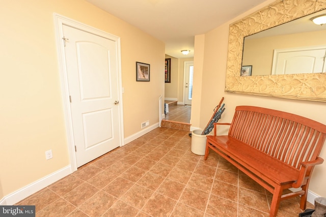 living area featuring tile patterned flooring and baseboards