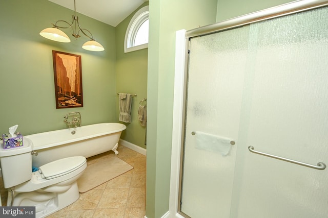 full bath featuring baseboards, a freestanding bath, tile patterned flooring, a shower stall, and toilet