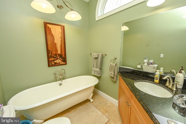 bathroom featuring vanity, a soaking tub, baseboards, and tile patterned flooring