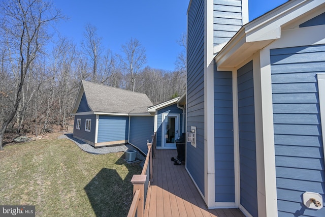 wooden deck with central air condition unit and a lawn