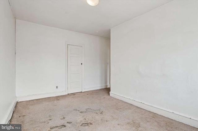 carpeted spare room with baseboards