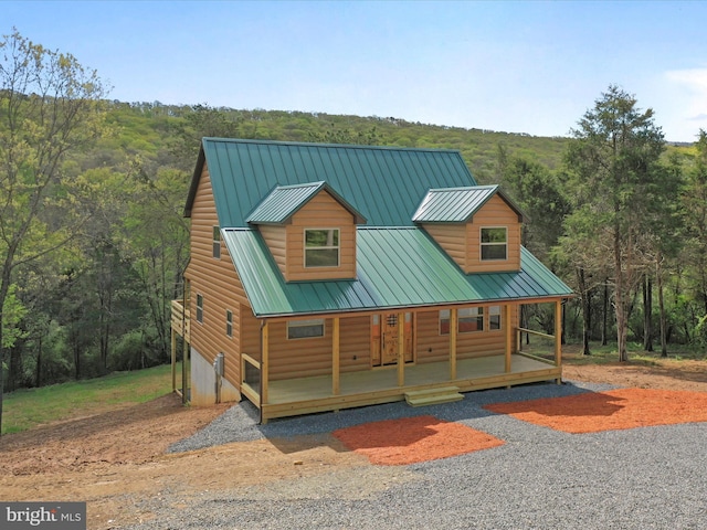 120 Honeymoon Hollow Rd, Lost City, WV 26810 - view of front of property featuring a porch, gravel driveway, a wooded view, and metal roof