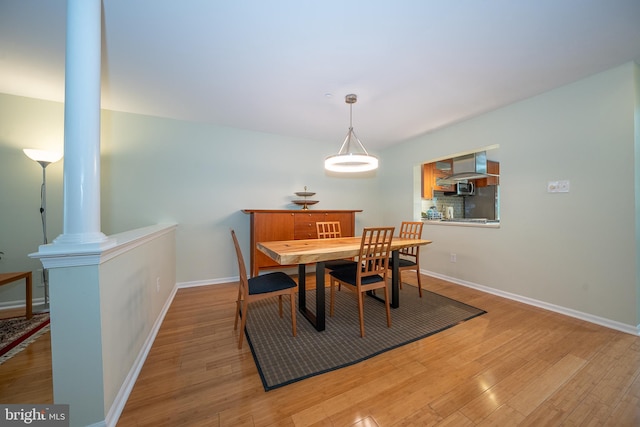 215 Valley Frg, Lookout Place, Wayne, PA 19087 - dining area with ornate columns, light wood-style flooring, and baseboards