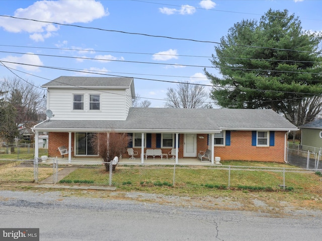 traditional-style house featuring brick siding, a porch, and a gate