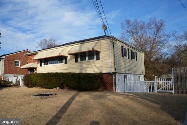 exterior space with brick siding and fence