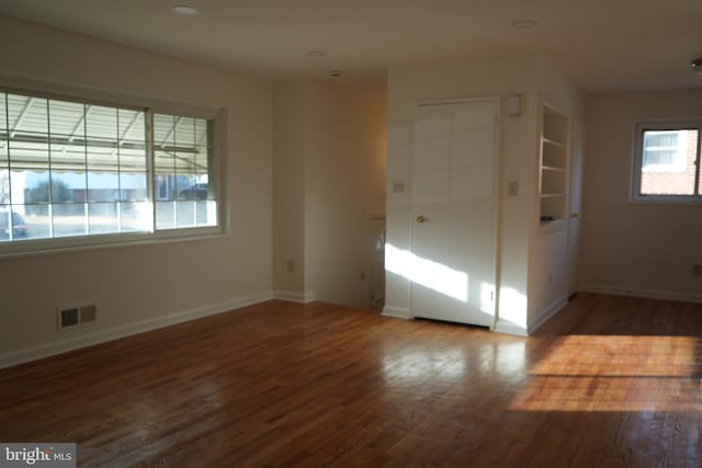 unfurnished bedroom featuring recessed lighting, visible vents, baseboards, and wood finished floors