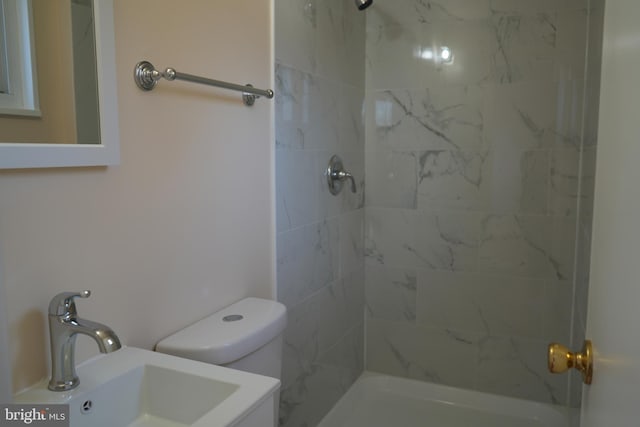 full bathroom with toilet, walk in shower, and a sink