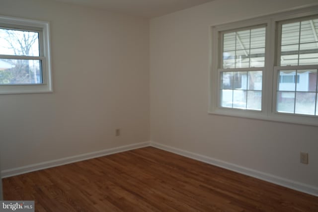 empty room with wood finished floors and baseboards