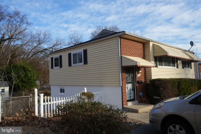 view of property exterior with fence