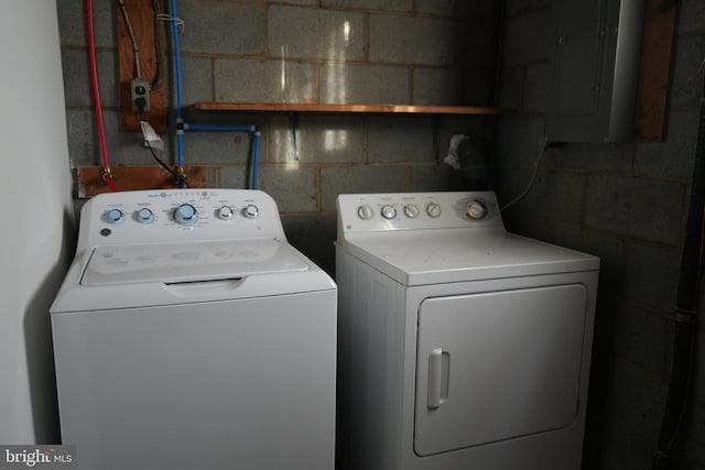 laundry room with electric panel, laundry area, and washing machine and clothes dryer