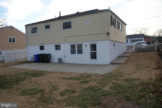 back of property featuring a patio, a yard, a fenced backyard, and stucco siding