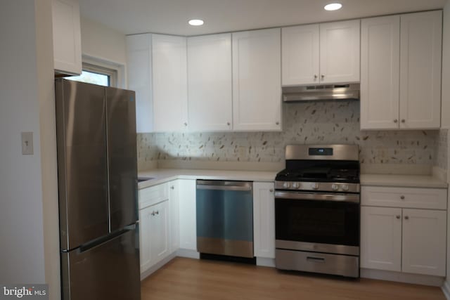 kitchen featuring under cabinet range hood, white cabinets, and appliances with stainless steel finishes