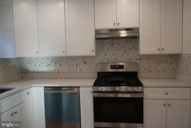 kitchen featuring under cabinet range hood, decorative backsplash, appliances with stainless steel finishes, and white cabinetry