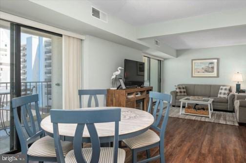 dining room with visible vents and wood finished floors