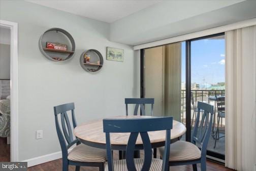 dining room featuring baseboards and dark wood-style floors