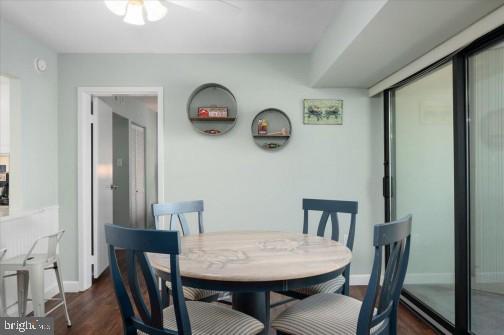 dining space with dark wood-style floors and baseboards