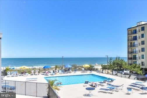 view of pool with a water view