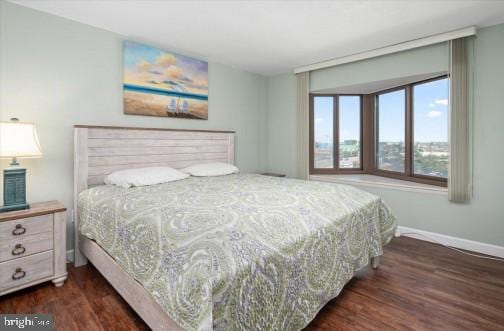 bedroom featuring dark wood-type flooring and baseboards