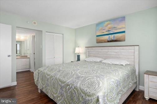 bedroom featuring wood finished floors, a closet, and baseboards