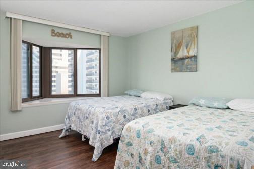 bedroom with wood finished floors and baseboards