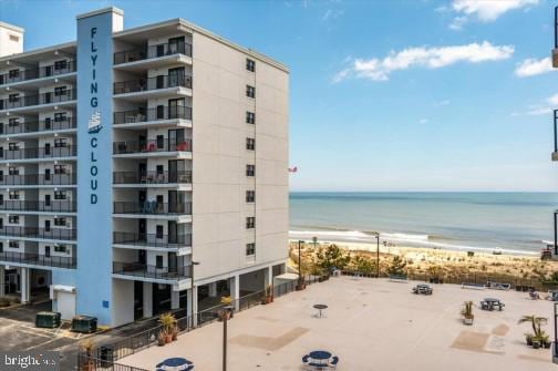 view of property featuring a beach view and a water view