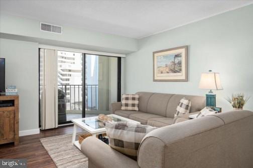 living area featuring visible vents, baseboards, and dark wood-style flooring