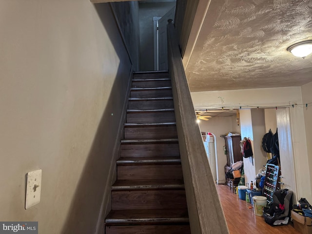 stairs featuring wood finished floors