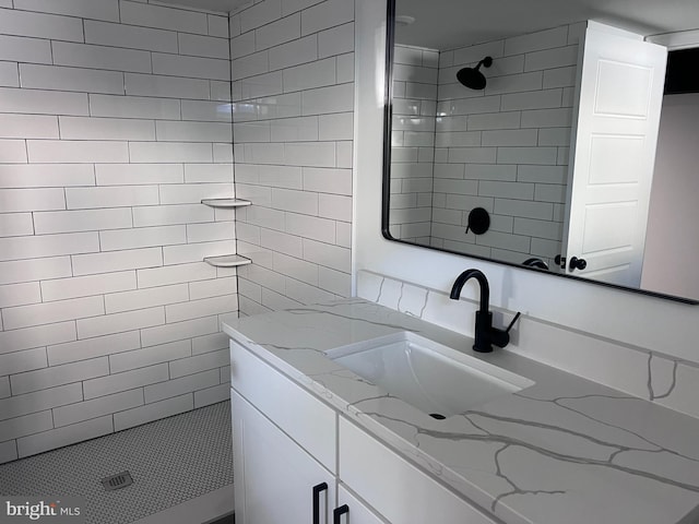 full bath with vanity and a tile shower