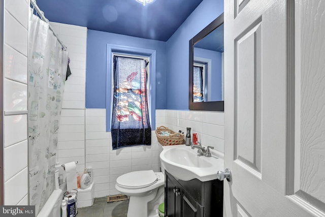 bathroom with visible vents, toilet, vanity, a shower with curtain, and tile walls