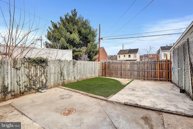 view of yard with a patio and a fenced backyard