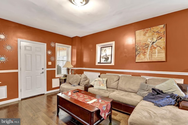 living area with baseboards and hardwood / wood-style floors