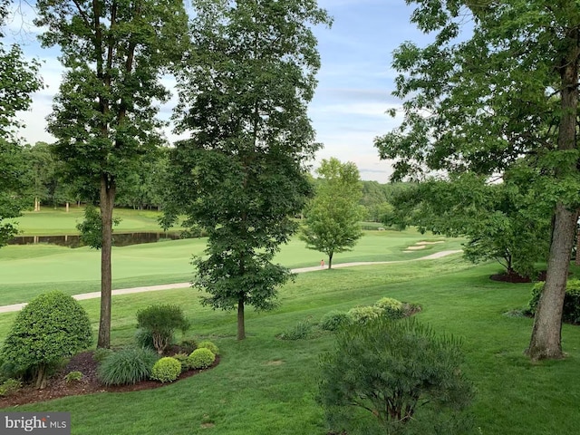 view of community with a lawn and golf course view