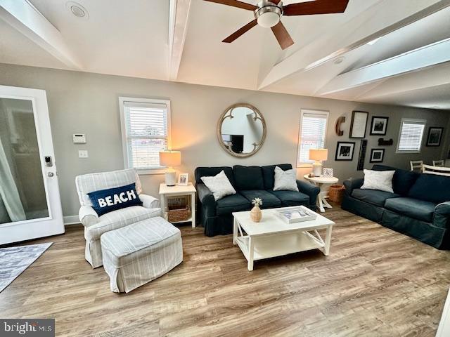 1 E Essex St, Fenwick Island, DE 19944 - living area featuring a ceiling fan, wood finished floors, plenty of natural light, and baseboards