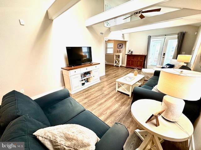 1 E Essex St, Fenwick Island, DE 19944 - living room featuring ceiling fan, light wood-style floors, and baseboards